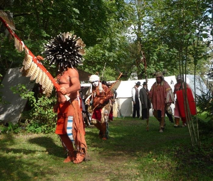 Mitglied in indianischer Darstellung mit Federstab im Lager